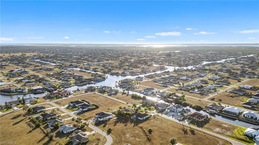 Aerial view of property's location with nearby suburban area and a large body of water