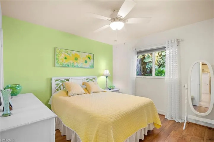 Bedroom featuring hardwood / wood-style floors and ceiling fan