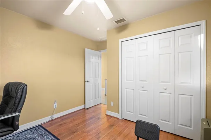 Office space featuring wood-type flooring and a ceiling fan