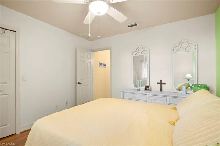 Bedroom with ceiling fan and wood finished floors