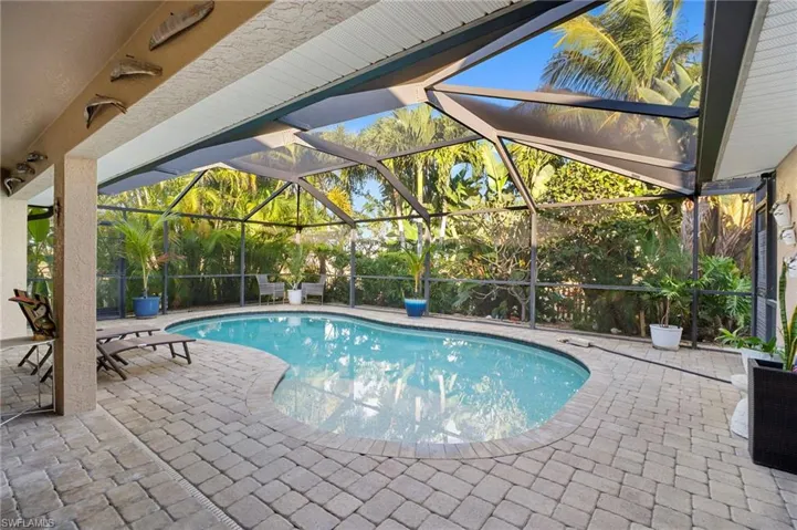 Outdoor pool featuring a lanai, a patio, and a sunroom