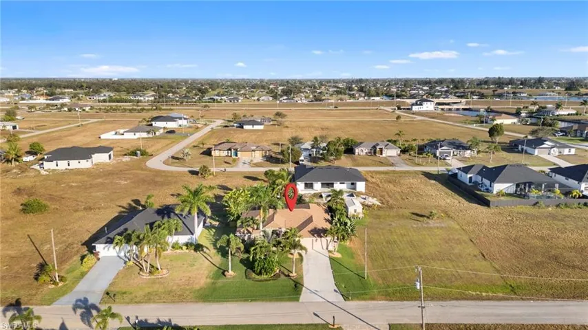 Aerial view of property's location featuring nearby suburban area