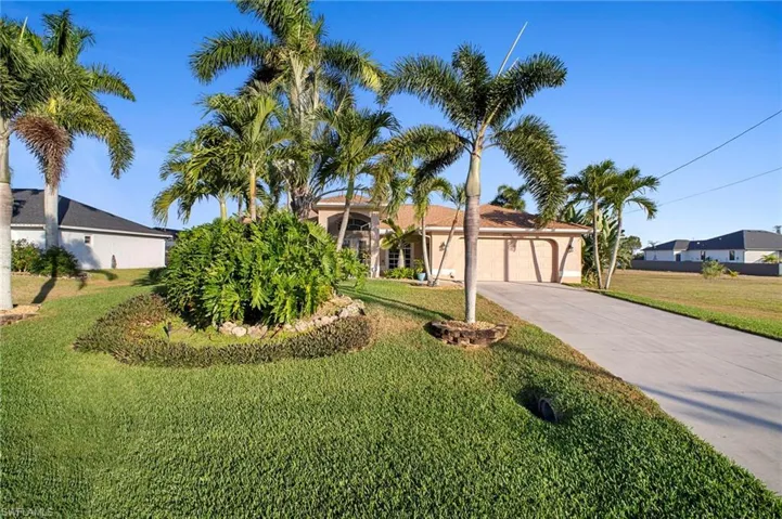 Ranch-style home with an attached garage, concrete driveway, and a front lawn