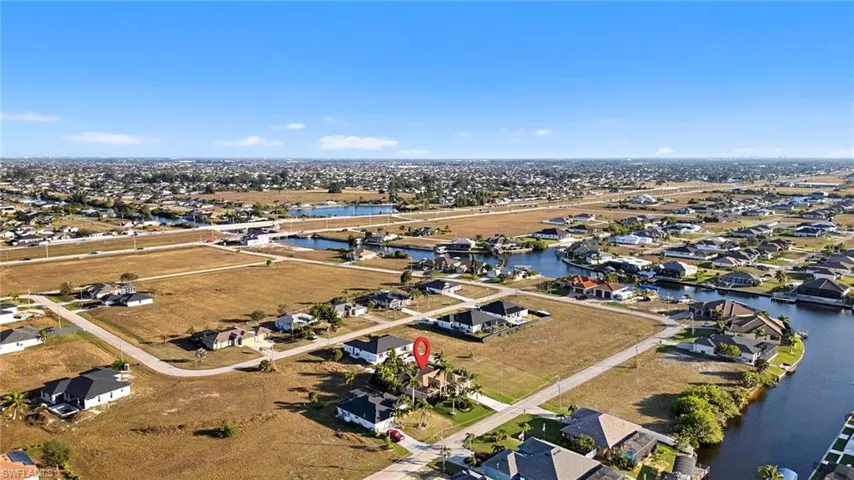 Aerial overview of property's location with a large body of water and nearby suburban area