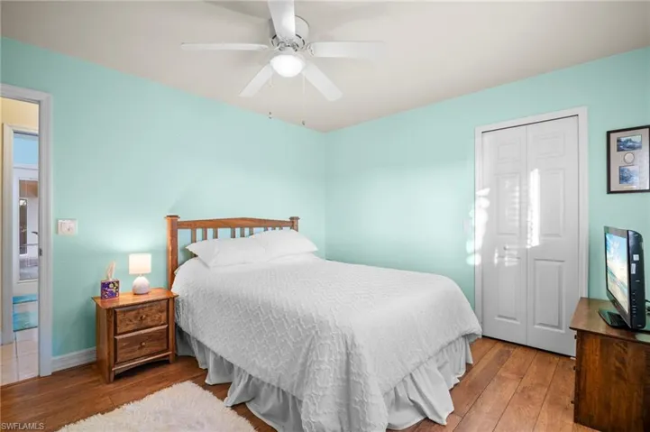 Bedroom with wood-type flooring and ceiling fan