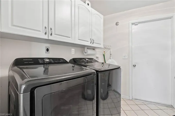 Laundry room comes with newer appliances and has plenty of storage