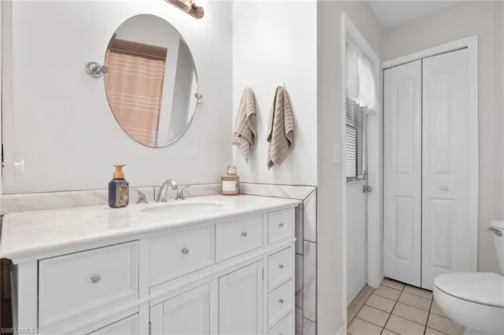 Guest bathroom doubles as pool bath with door leading in from the lanai