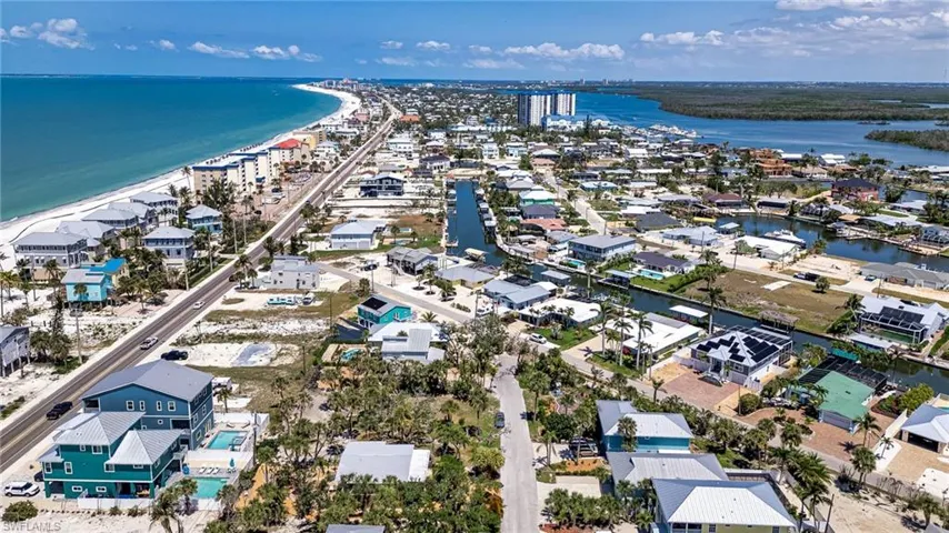 Aerial perspective of suburban area featuring a large body of water