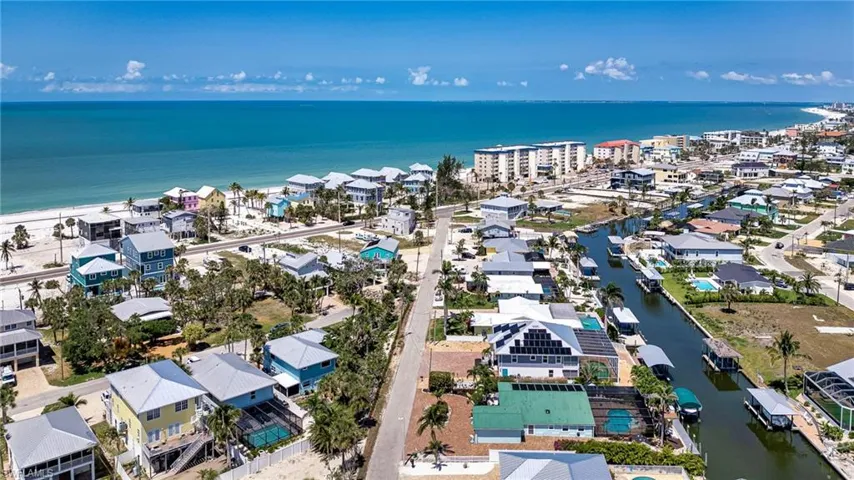 Aerial perspective of suburban area featuring a large body of water