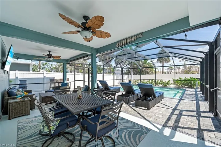 View of patio featuring an outdoor living space, a fenced backyard, and a ceiling fan