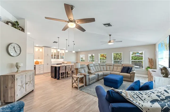 The Living room is nicely furnished and includes Hunter Douglas window treatments and vaulted ceilings