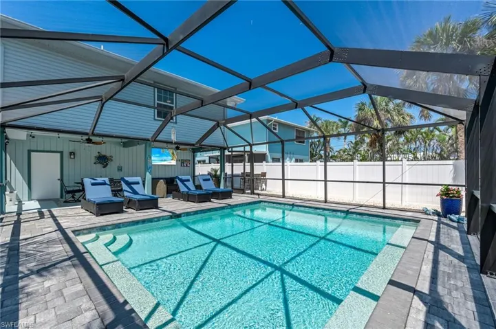 View of pool featuring an outdoor living space, ceiling fan, a patio, and fence