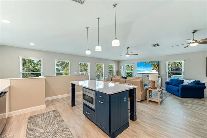 Luxury Vinyl Plank floors flow from the kitchen and throughout the living room
