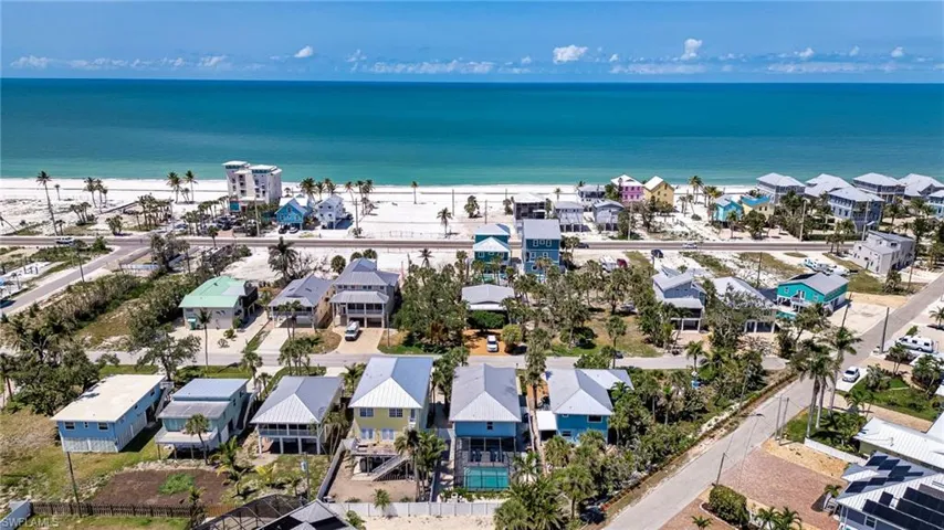 Aerial perspective of suburban area featuring extended coastline