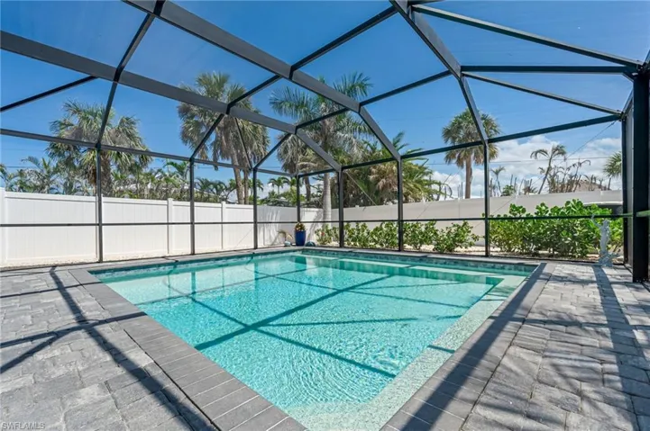 View of pool with a lanai and a patio
