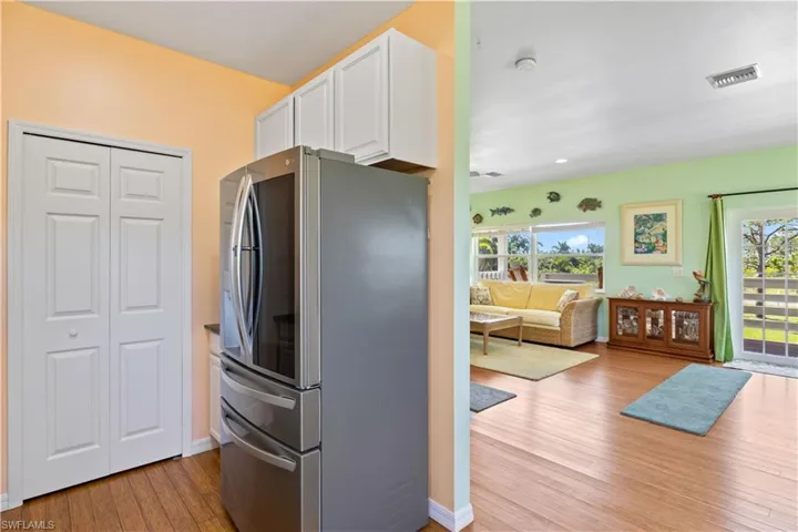 State of the art refrigerator and a double door laundry room / pantry.