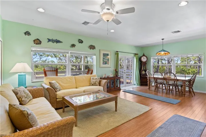 Double door entries and walls of hurricane impact windows create natural light and stunning tree views out of evry window!