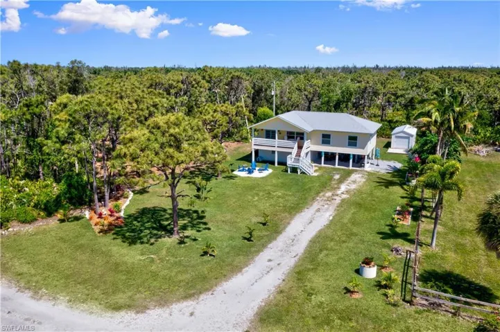 Looking from Fuller Street to the property and a wide span view - if you love gardening and nature, this home is calling your name!  Peacocks and eagles are just a few of your visitors and although this is a large lot, it is easily manageable!