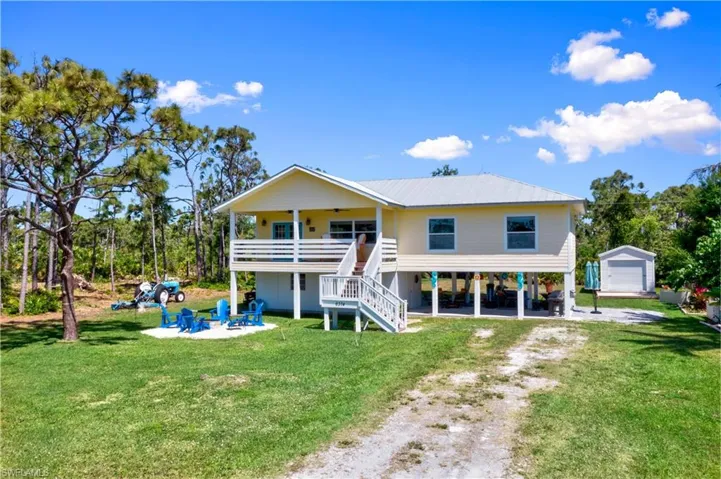 Island life!  Its incredible!  It is a life that embodies the simple yet enjoyabel things in life - this home is not your ordinary and average home - the property stretches all the way back and to the side with an additional half acre currently for sale (separately) for a possible two full acre square parcel.  Fencing on one side and semi cleared property to the right.