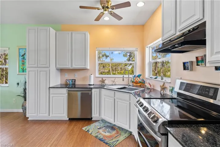 Corner view of the kitchen looking out to the trees - a seamless floor plan with super attention to detail and an absolute delight to show!
