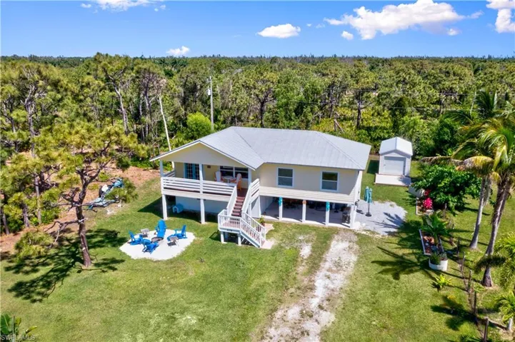 Daylight aerial view - owners LOVE living here and have added thoughtful touches throughout the outside - a seating area with firepit, beautiful planters, trees trimmed just perfect, cleared but not chopped down side half acre and the back half acre is in its natural state and spans all the way to Monteray Ave in the back!