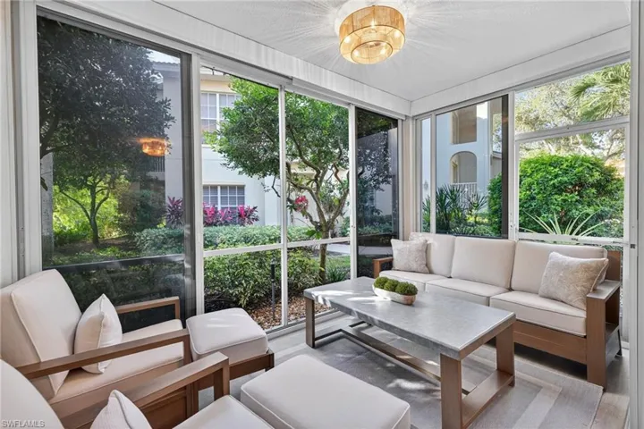 Sunroom featuring a chandelier and wood finished floors