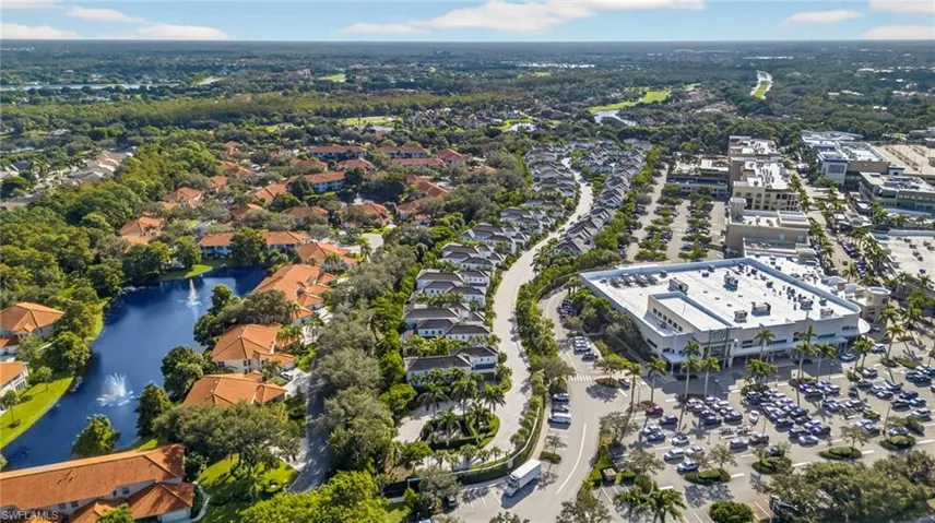 Aerial view of property and surrounding area with a large body of water