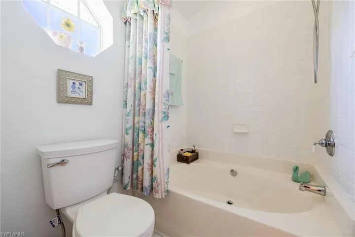 Master bathroom with toilet and shower / bath combination.