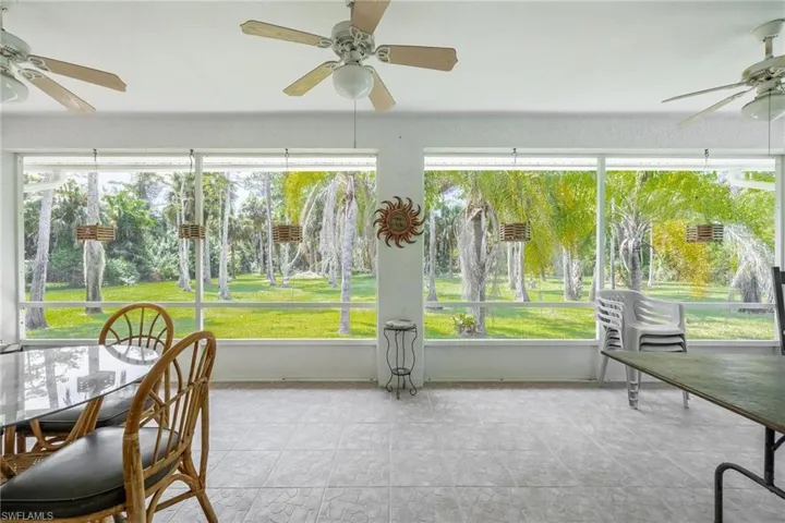 Sunroom with a healthy amount of sunlight and ceiling fans
