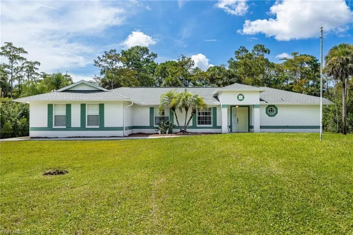 Single story home featuring a front lawn and covered porch