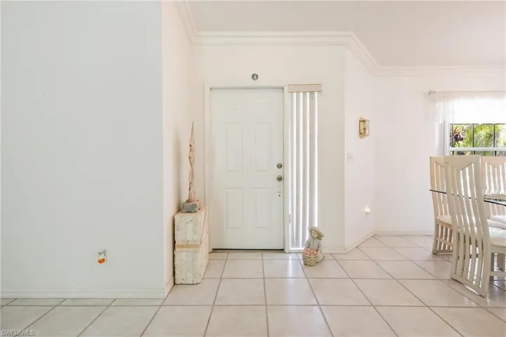 Tiled entrance foyer with crown molding