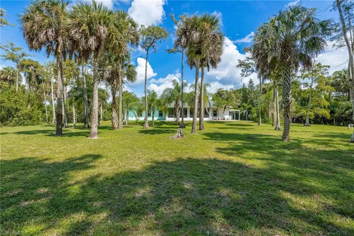 View of back of home and backyard.