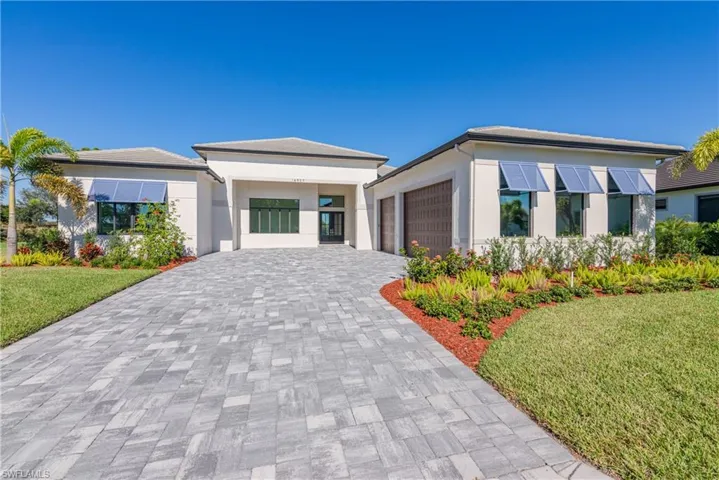 View of front of home with a garage and a front yard