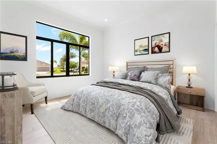 Bedroom featuring crown molding and light hardwood / wood-style flooring