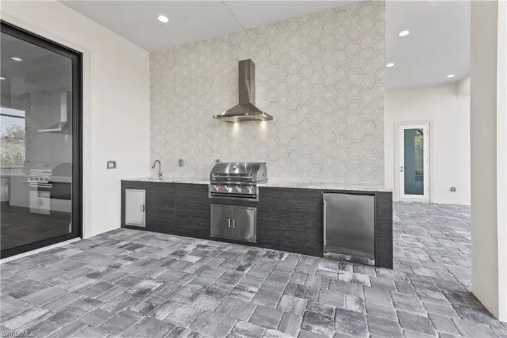 View of patio / terrace with a grill, sink, and exterior kitchen