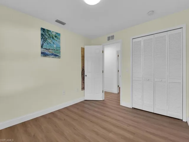 Unfurnished bedroom featuring light wood-type flooring and a closet