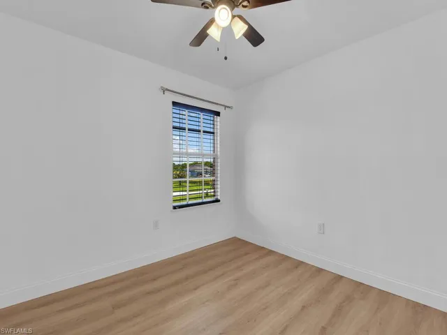 Unfurnished room with light wood-style floors and a ceiling fan