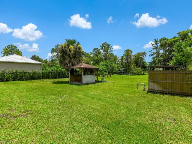 View of yard with a gazebo and view of wooded area