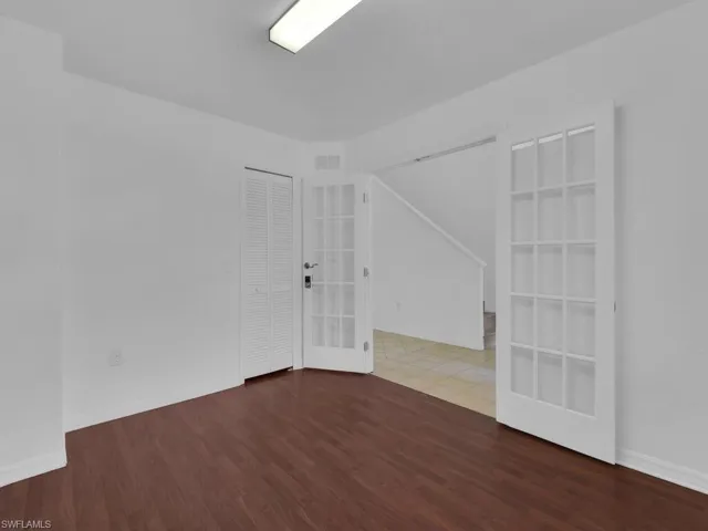 Spare room with french doors and wood finished floors