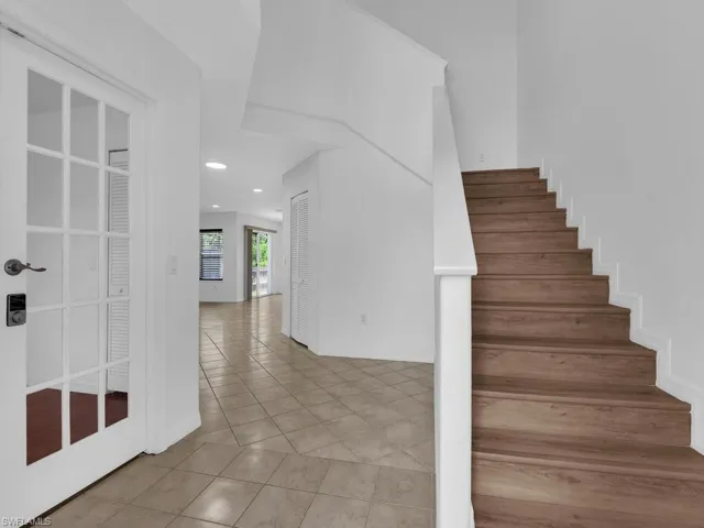 Stairway featuring recessed lighting and tile patterned floors