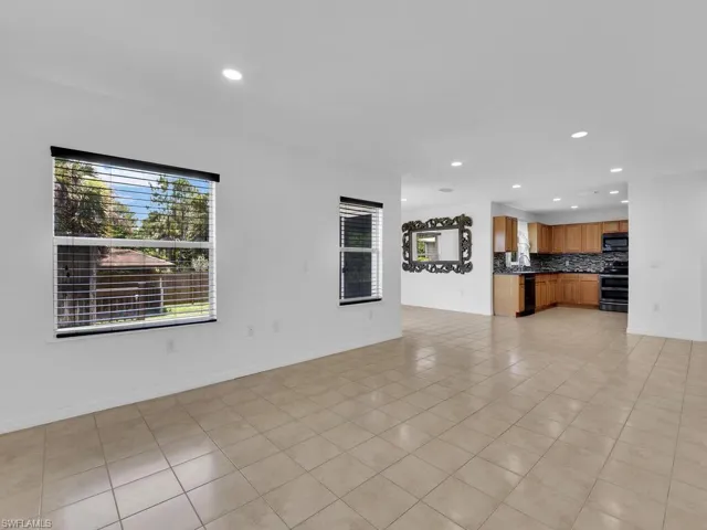 Unfurnished living room with recessed lighting and light tile patterned floors