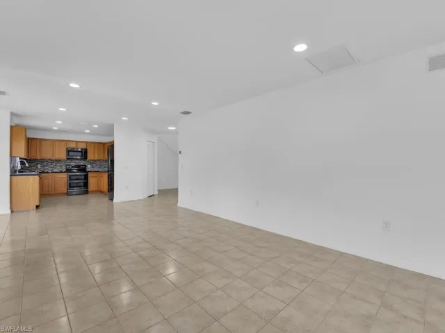 Unfurnished living room featuring recessed lighting and light tile patterned flooring