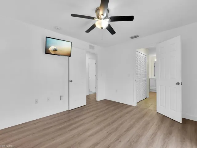 Unfurnished bedroom featuring light wood-type flooring and ceiling fan