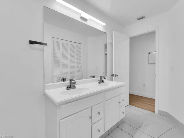 Bathroom featuring double vanity and tile patterned floors