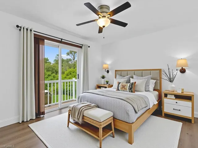 Bedroom featuring access to exterior, wood finished floors, and a ceiling fan
