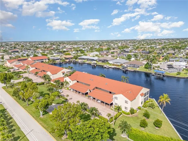 Aerial perspective of suburban area featuring a nearby body of water