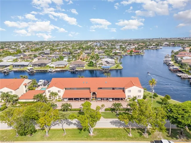 Aerial view of residential area featuring a large body of water