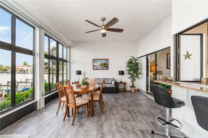 Sunroom featuring a water view