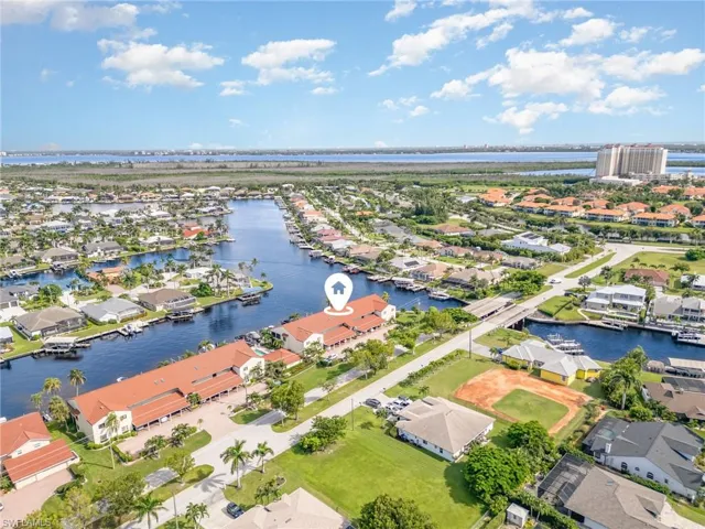 Aerial view of residential area featuring a nearby body of water