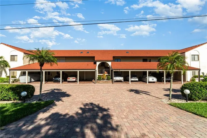 View of building exterior with covered parking